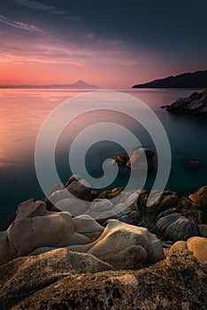 Amazing landscape of sunrise at sea. Colorful morning view of dramatic sky, seascape and rock. Long exposure image. Greece. Medite