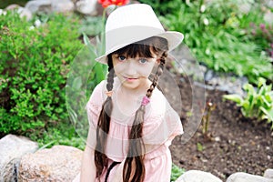 Amazing little girl in pink dress and white hat