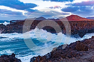 Amazing Los Hervideros lava caves in Lanzarote island at sunset, popular touristic attraction, Canary Islands, Spain