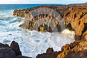Amazing Los Hervideros lava caves in Lanzarote island at sunset, popular touristic attraction, Canary Islands, Spain