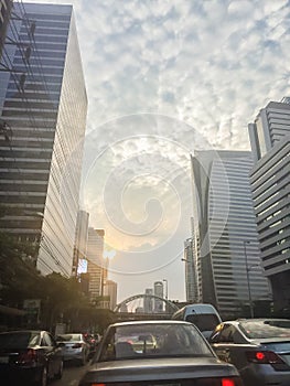 Amazing mammatus clouds over Bangkok, Thailand, with tall buildings foreground.