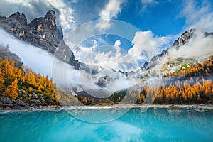 Amazing misty autumn scenery with lake Sorapis, Dolomites, Italy