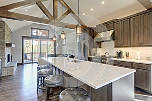 Amazing modern and rustic luxury kitchen with vaulted ceiling and wooden beams, long island with white quarts countertop