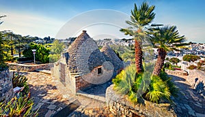 Amazing morning view of strret with trullo trulli -  traditional Apulian dry stone hut with a conical roof. Impressive spring ci