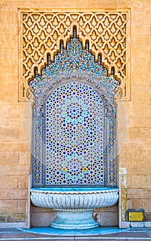 Amazing moroccan style fountain with fine colorful mosaic tiles at the Mohammed V mausoleum in Rabat Morocco. Artistic picture.