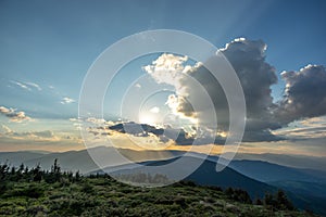 Amazing mountain landscape with colorful vivid sunset on the cloudy sky, natural outdoor travel background