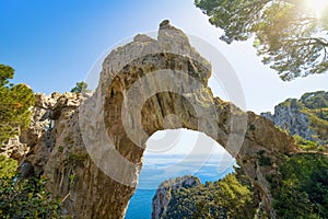 Arco Naturale is natural arch on coast of island of Capri, Italy photo