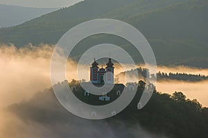 Amazing natural scenery with fog and a historical building obscured in the fog.