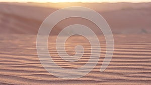 Amazing nature landscape at sunset in red desert with dunes and sandy ripples.