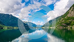 Amazing nature view with fjord and mountains. Beautiful reflection. Location: Scandinavian Mountains, Norway. Artistic picture.