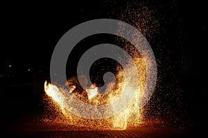 Amazing night paty fire show on black background photo