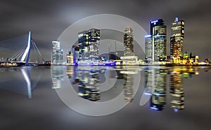 Amazing night reflection of Erasmus bridge and several skyscrapers in Rotterdam, Holland.