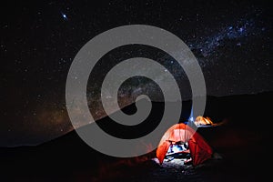 Amazing night scenery with beautiful milky way on the sky with camping tent in the foreground at Senaru Crater Rim, Mount Rinjani