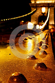 Amazing night view of the illuminated Chain Bridge close-up. Beautiful vintage lantern. Budapest