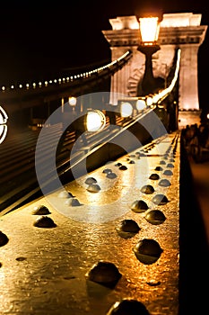 Amazing night view of the illuminated Chain Bridge close-up. Beautiful vintage lantern. Budapest