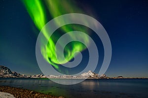 Amazing northern lights, Aurora borealis over the mountains in the North of Europe - Lofoten islands, Norway