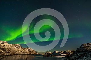 Amazing northern lights, Aurora borealis over the mountains in the North of Europe - Lofoten islands, Norway