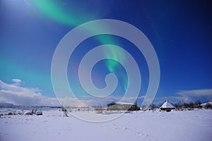 The amazing northern lights over the vast field in winter Iceland.