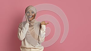 Amazing Offer. Excited Young Muslim Woman In Hijab Pointing At Copy Space