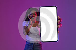 Amazing Offer. Surprised Black Woman Showing Blank Smartphone With White Screen