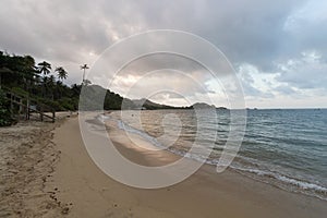 Amazing orange and yellow sunset landscape of La piscina beach into tayrona park