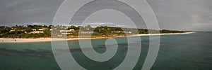 amazing panorama of beach clear green water and wooden fishing boat