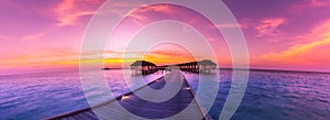 Amazing panorama beach landscape. Maldives sunset seascape view. Horizon with sea and sky. Tranquil scenery, tourism and travel