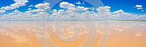 amazing panorama of Lake Elton on a summer day, beautiful sky with clouds and its reflection in the water