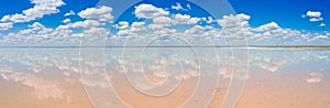 amazing panorama of Lake Elton on a summer day, beautiful sky with clouds and its reflection in the water