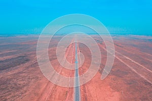 amazing panorama of the steppe and a straight line of the highway through the sandy desert in the Astrakhan region in