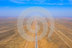 amazing panorama of the steppe and a straight line of the highway through the sandy desert in the Astrakhan region in