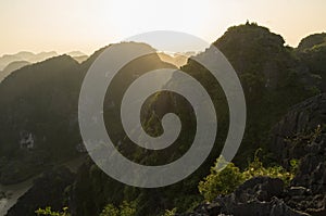 Amazing panorama view of limestone rocks and mountaintops from Hang Mua Temple at evening. Ninh Binh, Vietnam. Travel landscapes