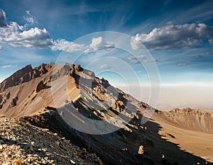 Amazing panoramic landscape of Mount Erciyes. View of the an inactive volcano: mountain range, stony slopes, rocky peaks formed by