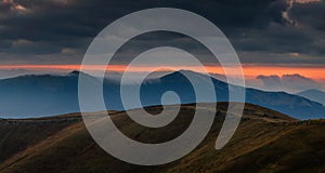 Amazing panoramic mountains landscape at dawn. View of dramatic morning sky and mountain ridges and slopes.