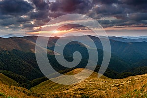 Amazing panoramic mountains landscape at dawn. View of dramatic morning sky and mountain ridges and slopes.