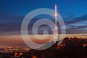 Amazing panoramic view of High Castle hill with illuminated TV tower against picturesque sunset sky, Lviv, Ukraine photo