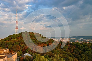 Panoramic view of High Castle hill with yellowed autumn trees and TV tower against picturesque sky, Lviv, Ukraine photo