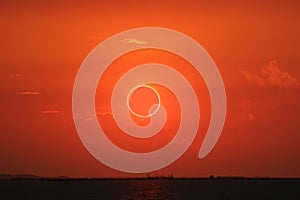 amazing phenomenon of total sun eclipse over cloud sunset red orange sky on the sea