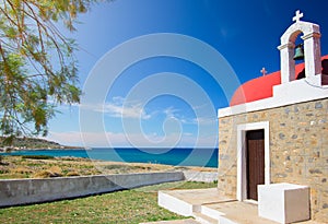 Amazing pictorial view of an old stone church beside blue sea, Milatos, Crete.