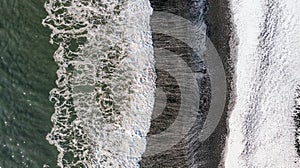 Amazing picturesque view of black sand beach with wave of Reynisfjara in the southern coast of Iceland in winter