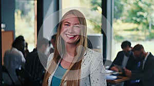 Amazing portrait of attractive successful young 30s blonde business woman posing at camera at modern office slow motion.