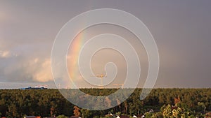 Amazing rainbow over the small village. Shot of amazing two rainbows that are appear over small village just after heavy