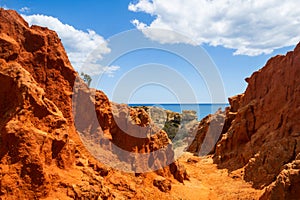 Amazing red sandstone rocks of the cliffs near Praia dos Paradinha, Albufeira, Algarve, Portugal photo
