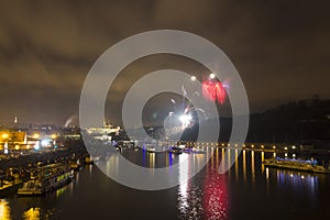 Amazing red and yellow firework celebration of the new year 2015 in Prague with the historic city in the background