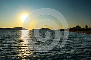 The amazing sandy beach of Gialova seaside town at sunset in Messenia, Peloponnese, Greece photo