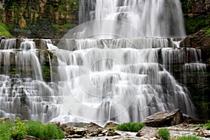 Amazing scene with waterfalls cascading over levels of ancient stone and sediment to the basin below