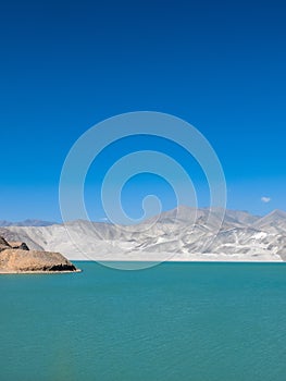 Amazing scenery of turquoise blue lake with white sand dune