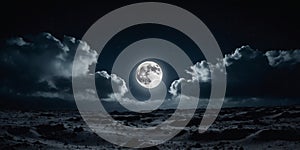Amazing scenery of white glowing moon with craters in black sky with clouds at night.