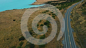 Amazing scenic windy road with mountains and glacier lake, aerial view. MT Cook State Highway 80, New Zealand.