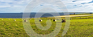 Amazing seascape with hay bales in the far north of Scotland near Wick, Caithness, Scotland